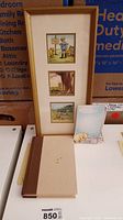 Photo of framed wall art with two Winnie the Pooh illustrations, a notepad shaped like Winnie the Pooh writing on a chalkboard, and a French edition book with a tan and brown cover.
