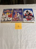 Front view of 3 VHS tapes in cases showing cover art for 101 Dalmatians x2 and The Aristocats