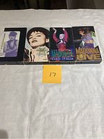 Front cover of 4 Madonna VHS tapes lined up with cases, showing cover art and titles