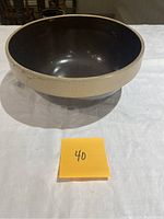 Top view of the glazed bowl showing dark brown interior with unglazed natural-colored rim.