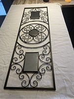 Full view of the rectangular aluminum wall hanger with 3 embedded mirrors on cloth background.