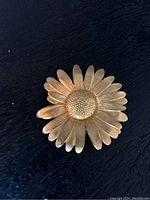 Gold-tone sunflower brooch front showing detailed textured petals and center