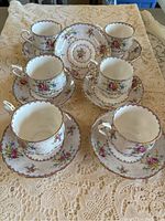 Full set of six Royal Albert bone china teacups each on matching saucers with extra saucer visible.