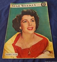 Cover photo of 1949 Star Weekly magazine featuring Elizabeth Taylor with a bright color portrait, earrings, necklace, and red and yellow outfit.