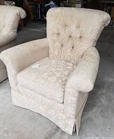 Front view of the brocade style chair showing tufted backrest and armrests with brocade polyester fabric upholstery.