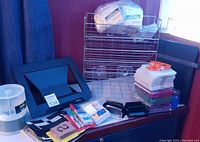 Overview of assorted office supplies including laptop stand, letter holders, stationery items, and plastic containers