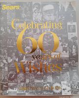 Front cover of Sears Christmas Wish List catalog collection with gold text 'Celebrating 60 years of Wishes' featuring a collage of historic catalogue covers in black and white.
