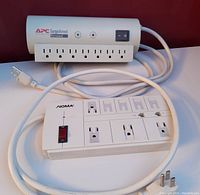 Photo showing both surge protectors together, highlighting size differences and cable length