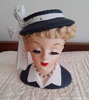 Front view of the vintage 1956 Napco ceramic Lady Head Vase resembling Lucille Ball with painted facial features, hat and necklace.