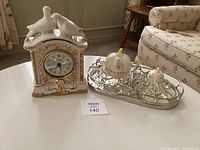 Full view of the clock, pumpkin coach set, and mirrored tray arranged on a table.
