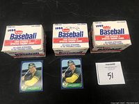 Three 1986 Fleer Baseball update card boxes with text stating 22 logo stickers & 132 trading cards. Two Jose Canseco cards are shown in front of the boxes.
