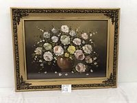 Frontal view of the floral oil painting on canvas including the decorative ornate frame.