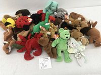 Photo showing the full collection of Beanie Babies plush toys in various animal designs and colors with TY tags visible.