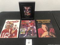 Full lot with framed photo and three magazines displayed on table