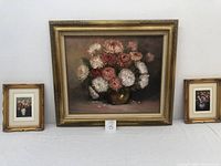 Full view of the lot showing one large original oil painting flanked by two smaller framed floral prints, all in gold-tone frames.