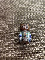 Top front view of small cloisonné owl figurine showing detailed enamel work on body, eyes, and wings.