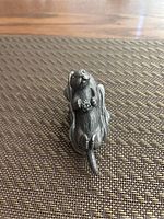 Top view showing the otter lying on its back with detailed feet and head.