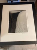 Full view of framed black and white sand dune photograph, showing texture and composition.