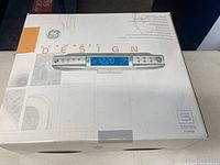 Box of GE Acemaker Design S Series under counter radio with CD and MP3 functionality, showing product image and some text.