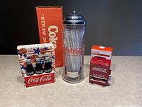 Full lot showing glass straw dispenser with box, toothpick dispenser with box, and napkin holder with napkins