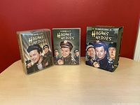 Full view of the box set with three parts: two DVD cases containing seasons 1-4 and 5-6, and the outer slipcover showing the series title and characters.