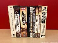 Side view of DVD cases featuring various Western series and collections including Hopalong Cassidy, Bonanza, Gunsmoke, and The Great Alaskian Westerns.