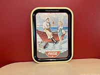 Front view of vintage Coca Cola 50th anniversary tin tray with ocean and boat illustration and gold-bordered edges