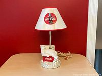Full view of the Coca Cola table lamp showing the polar bear lounging on the cooler and the original lamp shade with Coca Cola logo.