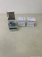 Three boxed Edwards transformers with one opened box showing a transformer inside.