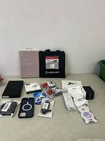 Overview of electronic and cell phone accessories including cables, chargers, earphones, and phone cases mostly in original packaging.