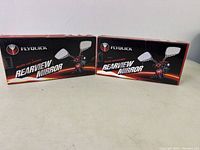 Two boxed Flyquick rearview mirrors placed side by side on a surface, showing the product branding.