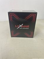 Front of sealed black Laxmas LED lighting box with red 'X' design and logo.