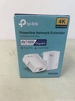 Front view of the TP-Link Powerline Network Extender box showing model and key features including AV1000, Gigabit Ethernet, plug and play.