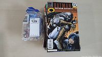 Photo showing several DC Comics including Batman Gotham Knights with distinctive cover art