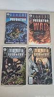 Four Aliens vs Predator comic books arranged in two rows; covers show dark sci-fi action scenes with alien and predator creatures.
