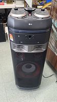 Full front view of LG mini hi-fi audio system tower showing speaker grille and control panel