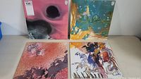 Four LP record covers showing abstract artwork in different color themes: dark pink/black, yellow/blue, red, and white with red and orange accents.