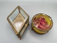 Two antique French jewelry or vitrine display boxes, one square with gilt metal and crystal glass and one round with yellow tinted glass and silk lining.