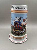 Full view of the porcelain German reservist stein featuring soldier on horseback and inscriptions on the upper rim.