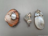 Top view showing three shell boxes with metal decorations and clasps.