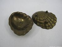 Top open view showing interior and brass natural patina of both seashell dishes, used condition with wear and marks.