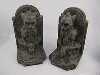 Front view of both gargoyle cement bookends showing frontal gothic design and symmetric poses