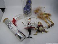 Group photo showing six assorted vintage Christmas ornaments including two camels with fur, glass swan, tin cylinder, and two figurines.