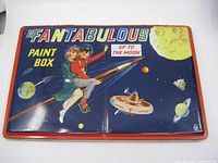 Front view of the Fantabulous paint box showing full cover graphic with children on a rocket, planets, space station, and text 'Up to the Moon'.