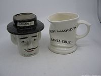 View of both ceramic souvenir cups side by side, showing their size and design.