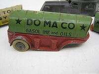 Top-side view of green Domaco fuel trailer with red base, showing age wear and black lettering