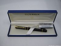 Waterman Paris fountain pen in original blue box with white interior lining. Pen is secured with white ribbon. Includes a small folded instruction or info leaflet.