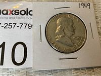 Front side of 1949 Ben Franklin half dollar coin showing Benjamin Franklin's profile and inscriptions.