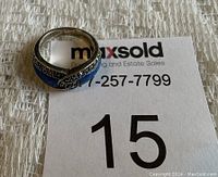 Silver ring on MaxSold bidding card showing ring details and 92.5 purity mark