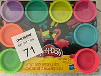 Top view of unopened Play-Doh 10-pack showing colorful containers on original packaging with product label and brand logo.
